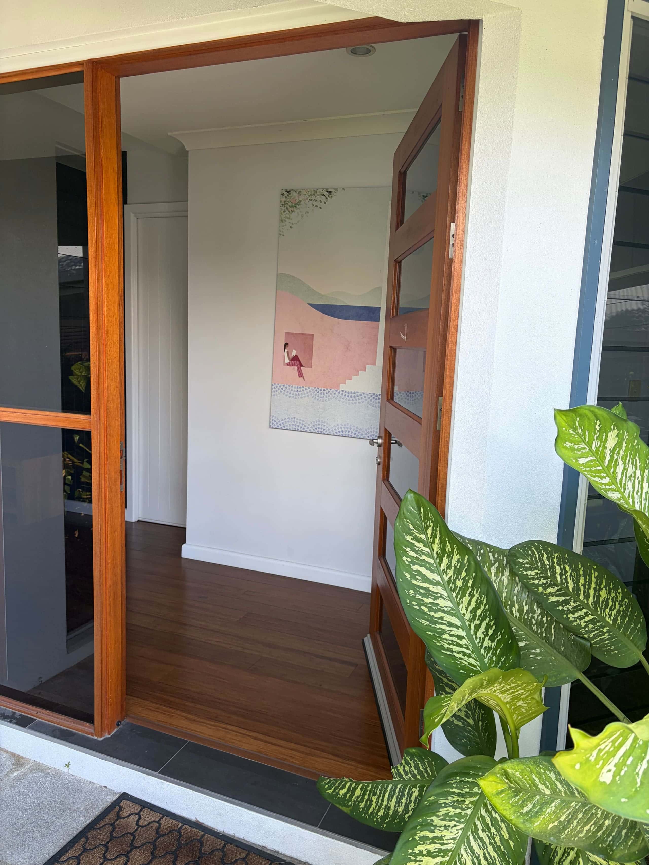 Timber-framed front entry with bamboo floors and tropical greenery